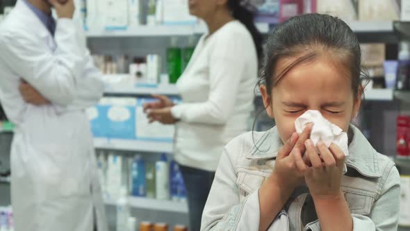 The Sick Girl Sneezes and Looks Very Tired