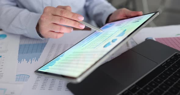 Accountant Working on Electronic Gadgets Preparing Financial Report on Tablet