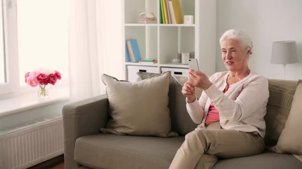 Old Woman with Smartphone Having Video Chat