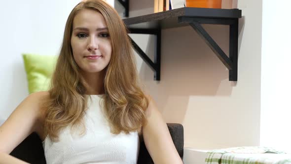 Denying, No gesture by Cute Beautiful Girl, Sitting on Sofa