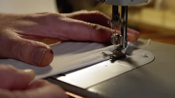 Tailor at Sewing Machine Sews a Homemade Medical Face Mask To Protect Covid-19