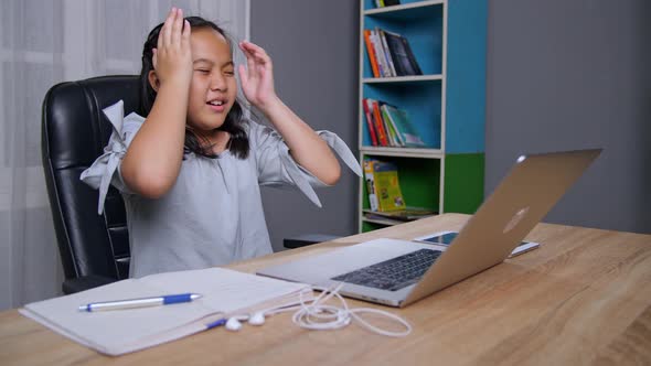 Asian Little Girl Frustration With Laptop At Home