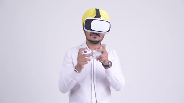 Happy Indian Sikh Businessman Playing Games with Virtual Reality Headset