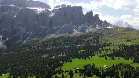 Aerial flight above stunning Alps in Italy. High mountain peaks sharp cliffs in Dolomites