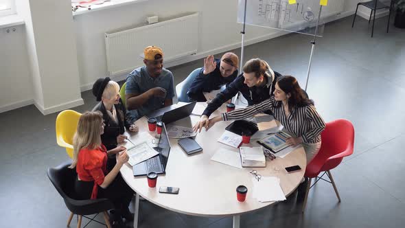  Young Successful and Creative Multi Ethnic People Stacking Hands Together for New Project