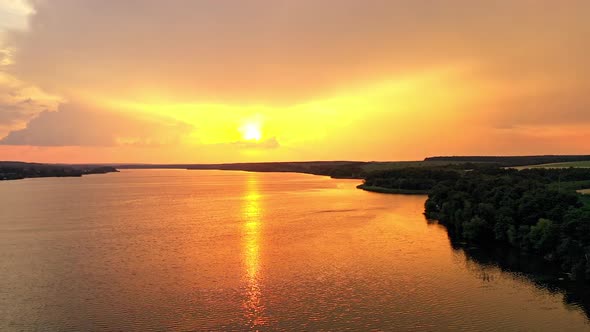 Beautiful orange sunset over the calm river.