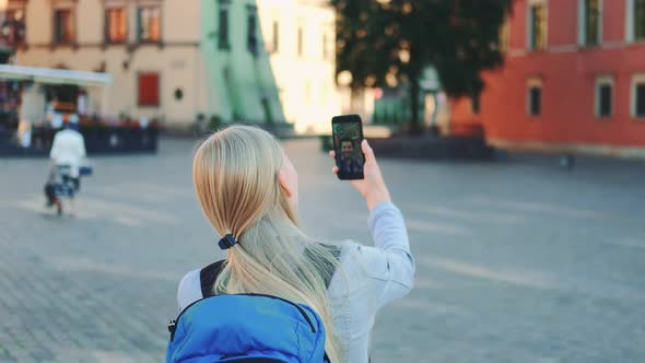 Back View of Female Tourist Making Video Call on Smartphone with Her Friend From Other Place