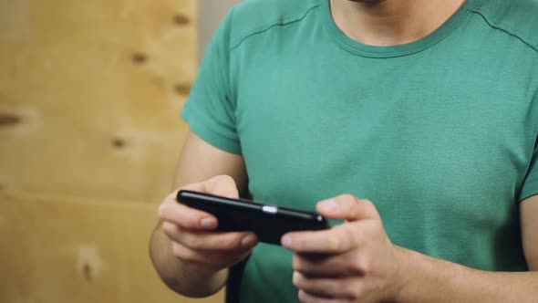 Man Playing Online Game on His Smartphone, Addictive Arcade, Time-Killer