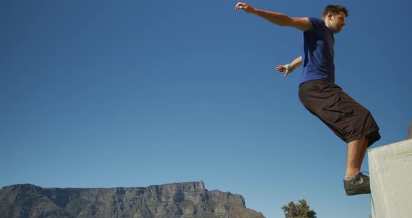 Caucasian man practicing parkour