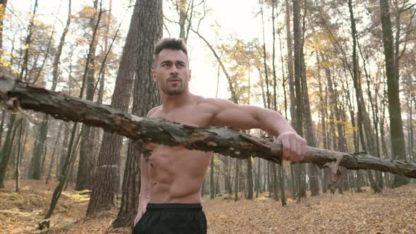 Young Man Doing Exercises In The Forest