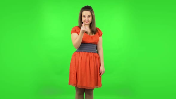 Cute Girl Smiling and Showing Heart with Fingers Then Blowing Kiss. Green Screen