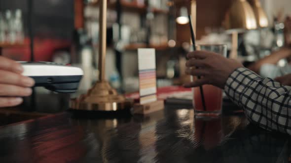 Man Paying Bill Through Smartphone Using NFC Technology in Cafe Drink Lemonade to Go