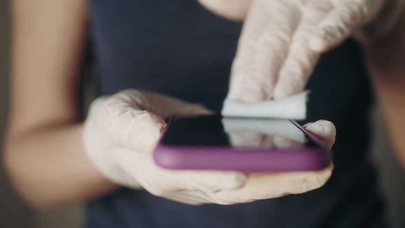 Man Disinfecting His Smartphone. Anti Coronavirus Protection, Hands Desinfecting Phone After Use