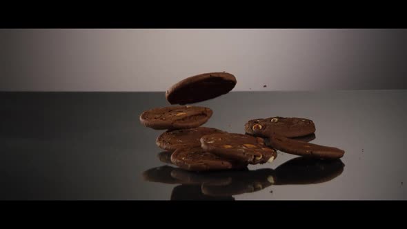 Falling cookies from above onto a reflective surface - COOKIES 199