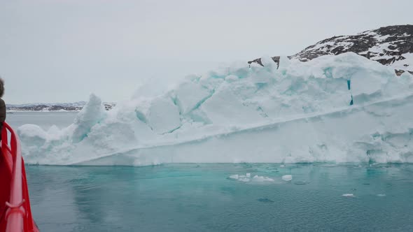 Deck Of Boat Passing Iceberg On Calm Sea