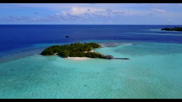 Aerial flying over scenery of exotic lagoon beach vacation by blue water with white sandy background