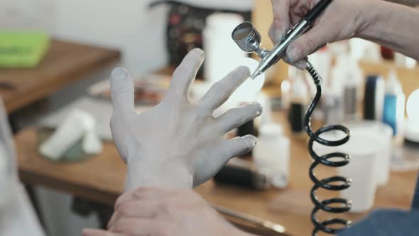 SFX Makeup Artist Applying Body Paint on Hand