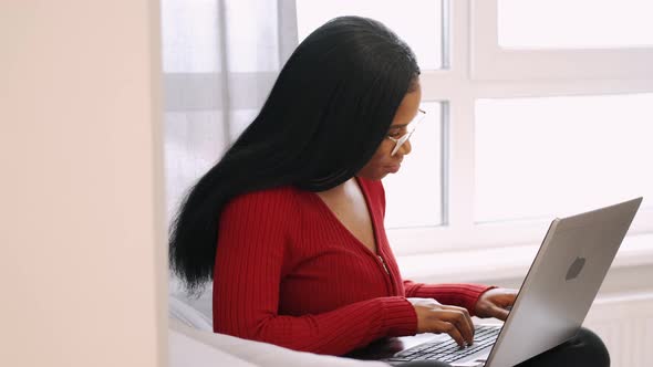 African American Woman with Laptop Working at Home