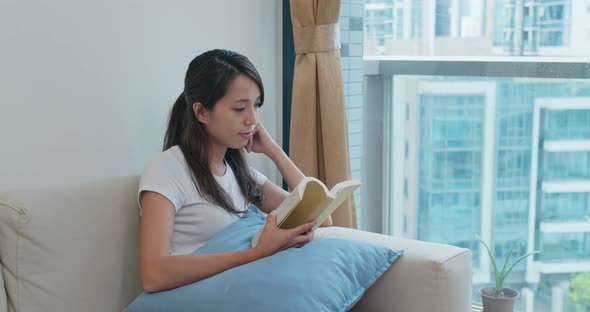 Woman read book at home