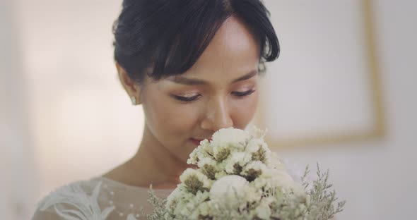 Beautiful Asian Bride In Wedding Dress With Flowers Bouquet, Slow Motion Shot.