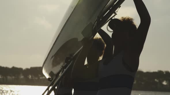 Female rowing team training on a river