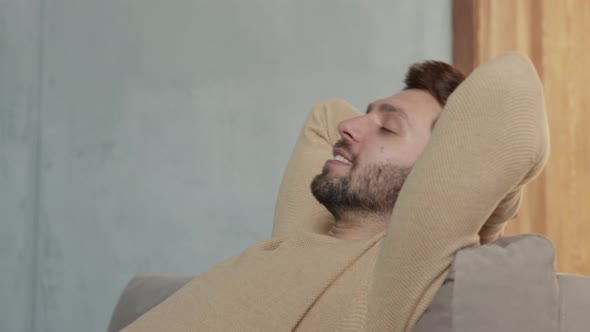 Young male relaxes on the sofa in a calm atmosphere alone