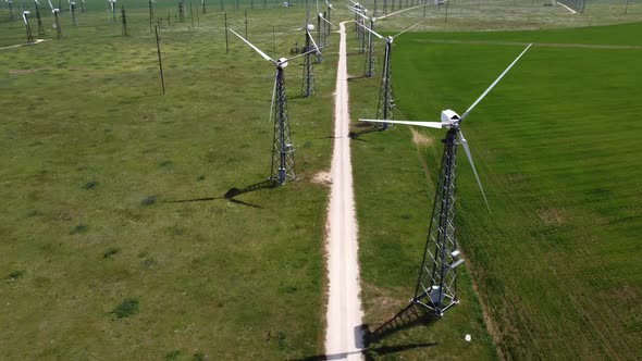 White Windmills Among the Field Shooting From a Bird'seye View By a Drone