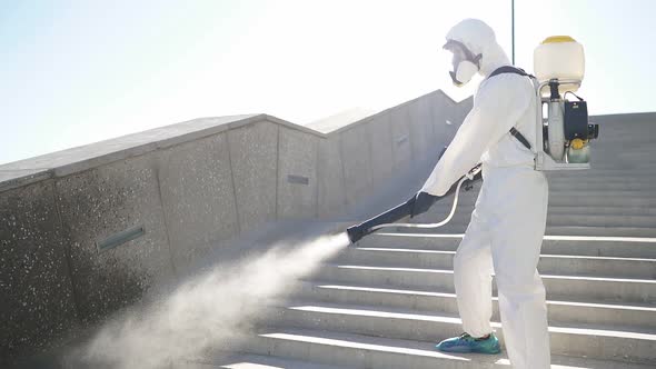 Disinfector in Protective Antiviral Suit, Chemical Decontamination Sprayer Bottle Outdoors