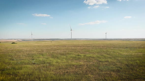 Aerial View of Wind Turbine on a Field in a Summer Day