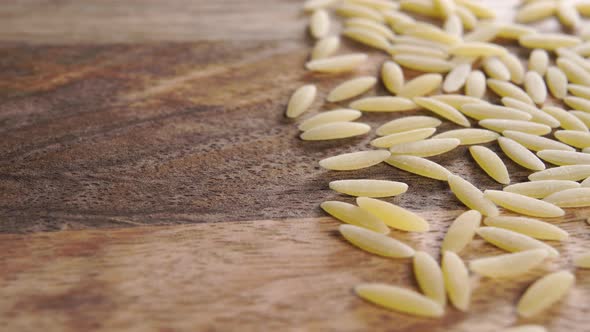 Dry peeled barley on a wooden surface. Macro