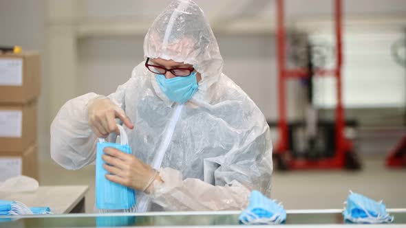 Production of Medical Masks - Staff Worker Packing the Masks in a Pile