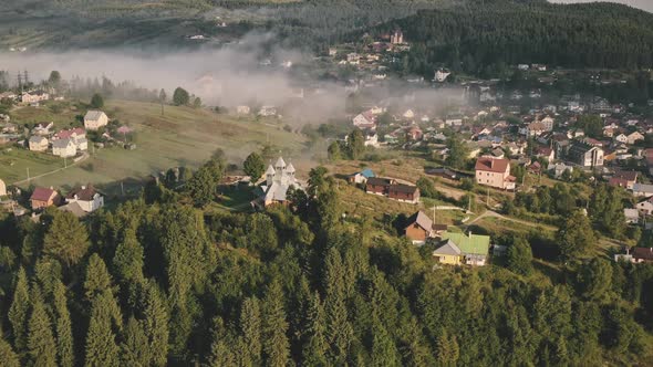 Aerial Carpathian Mountain Village in Morning Fog