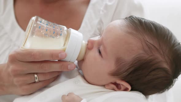 Mother Bottle Feeding Baby Girl