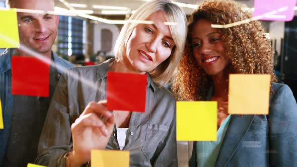 Businesswoman writing on sticky notes