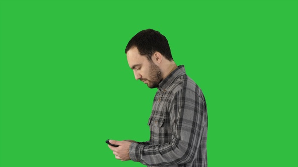 Young smart casual business man reading message on cell