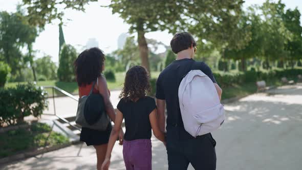 Handsome multiethnic family walking in the park