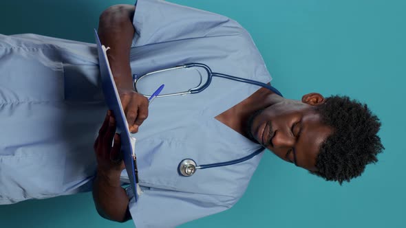 Man Working As Nurse and Writing on Medical Paper