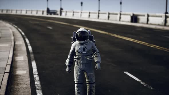 Astronaut in Space Suit on the Road Bridge alt