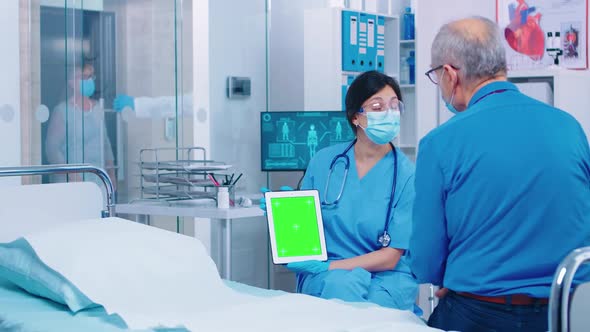 Patient Looking at Green Screen Digital Tablet