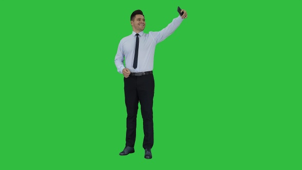 Handsome man taking a selfie Fast selfie on a Green Screen