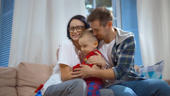 Mother, Father and Little Son at Home Spending Time Together