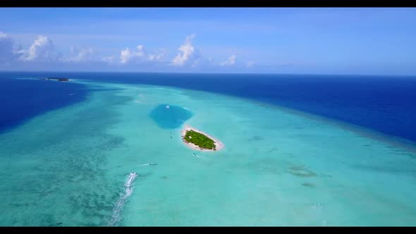 Aerial view scenery of relaxing tourist beach adventure by aqua blue lagoon and white sandy backgrou