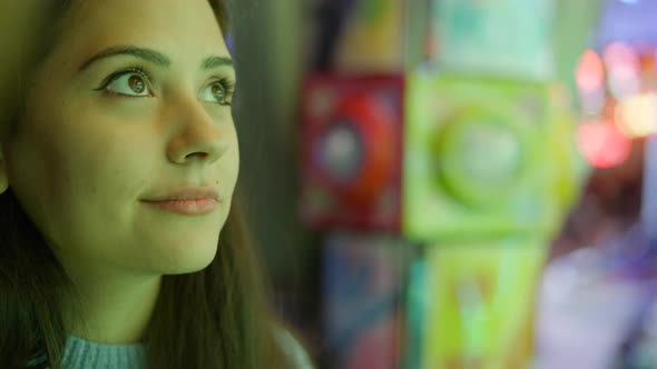 Beautiful Young Adult Woman Face Closeup Under Different Changing Colorful Shimmering Lights in