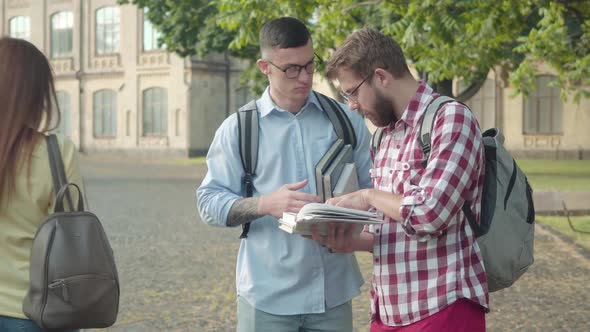 Absorbed Smart Boys Discussing Studying in College Yard As Female Groupmates Passing By. Portrait of