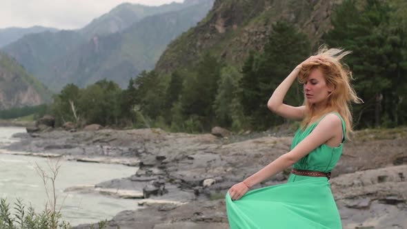 Young Woman in a Long Flowing Dress on the Background of the River and Mountains. Coloring Women