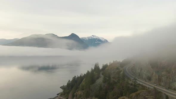 Aerial panoramic view of Sea to Sky Highway near Horseshoe Bay during a sunny winter evening before
