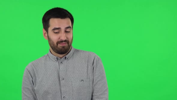 Portrait of Brunette Guy Is Daydreaming and Smiling Looking Up. Green Screen