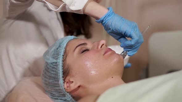 Woman in a Spa Getting Facial Mask