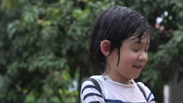 Cute Asian Child Playing With Water Gun In The Summer4k3