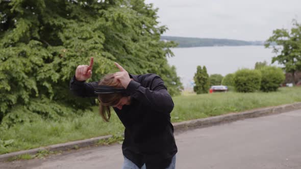 A Man Listens to Music and Dances in the Middle of the Park